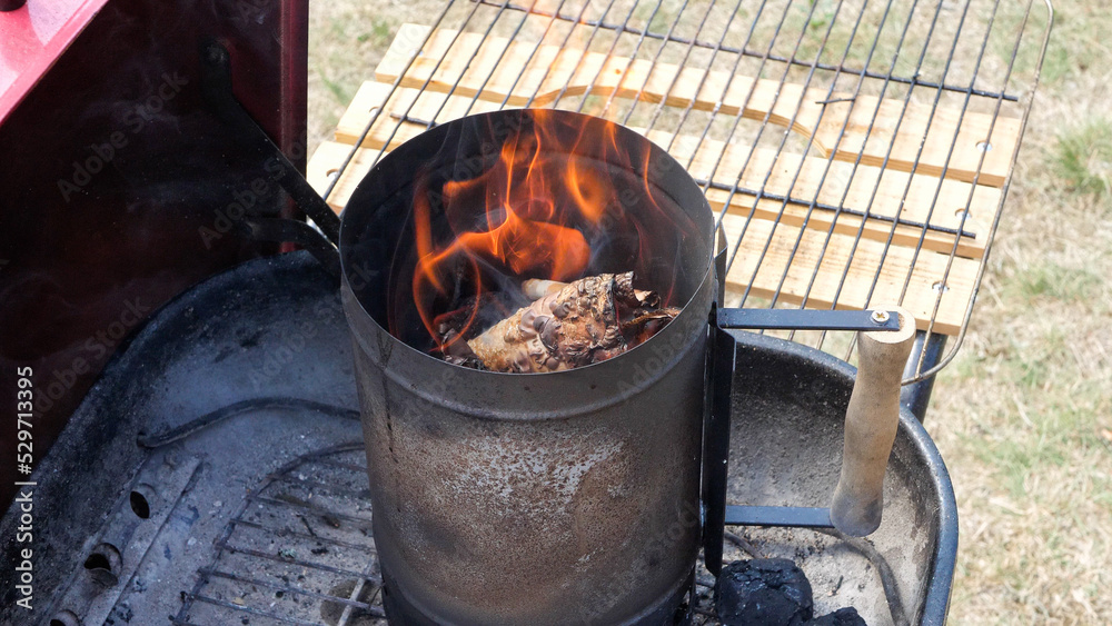 Coal burning fire in a charcoal chimney grill starter Coal burning fire in a charcoal chimney grill starter