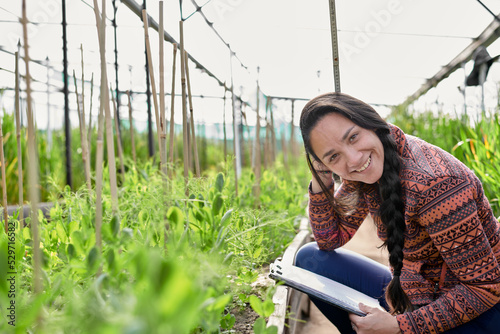 Female  native american research assistant on the field in a greenhouse