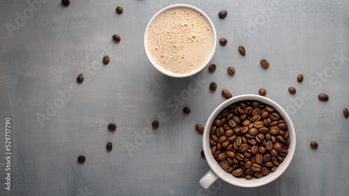 Coffee beans and coffee bewerage on a gray background. Top view, copy space. photo