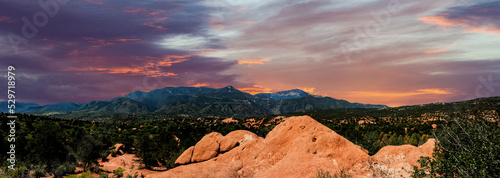 Panoramic landscape view from the Garden of the Gods park looking towards the west and Pikes Peak at the spectacular sunset. 