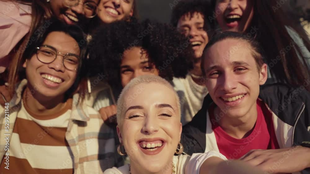 Multiethnic group of young friends taking a selfie. and having fun.The focus is on shaved hair woman. Multiethnic group of young friends taking a selfie. and having fun.The focus is on shaved hair woman.