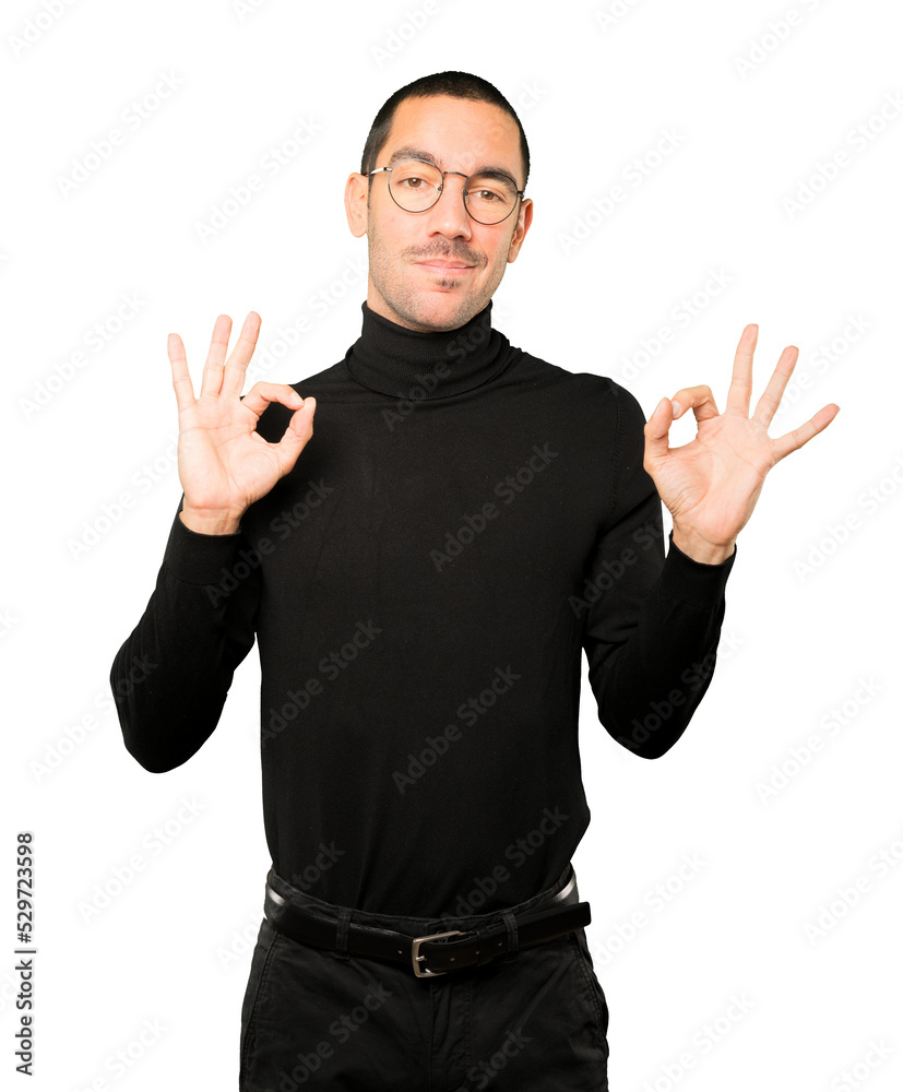 Worried young man doubting and making a gesture of approval Worried young man doubting and making a gesture of approval