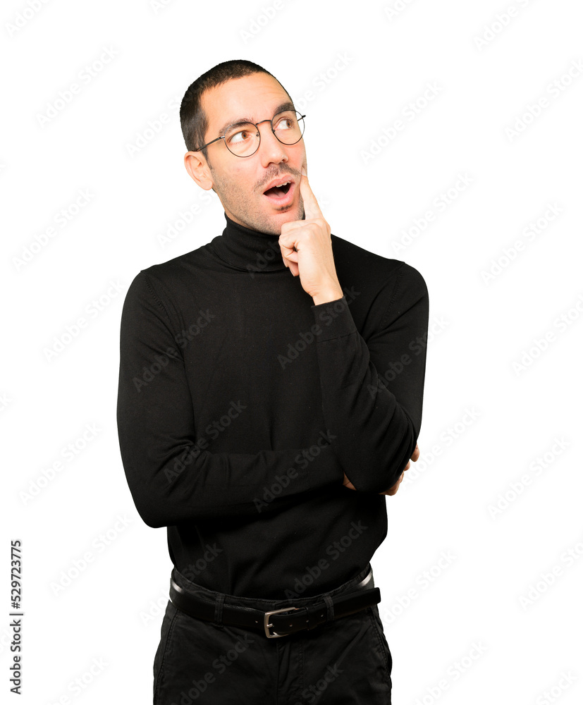 Surprised young man making a gesture of doubt Surprised young man making a gesture of doubt