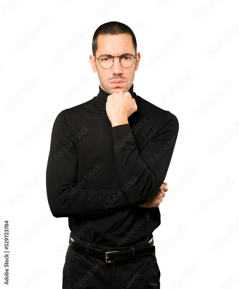 Angry young man posing against background Angry young man posing against background