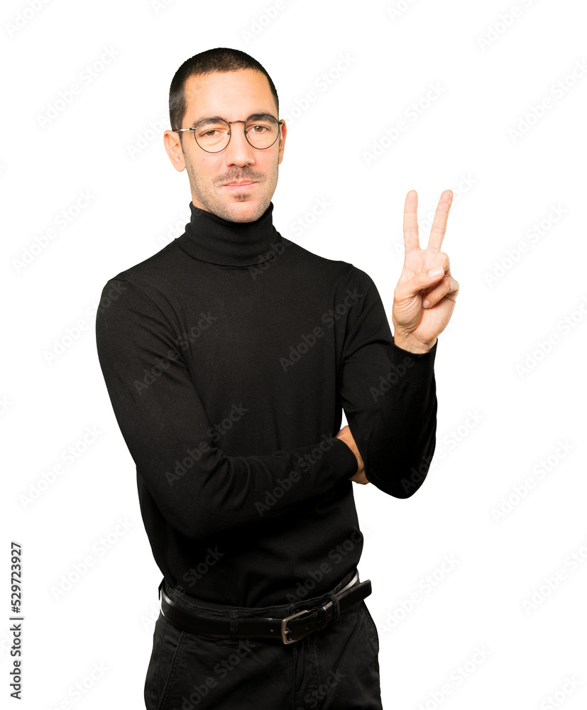 Young man making a number two gesture Young man making a number two gesture