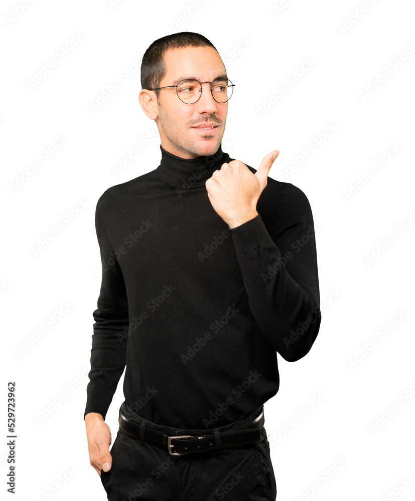 Hesitant young man gesturing that everything is fine Hesitant young man gesturing that everything is fine