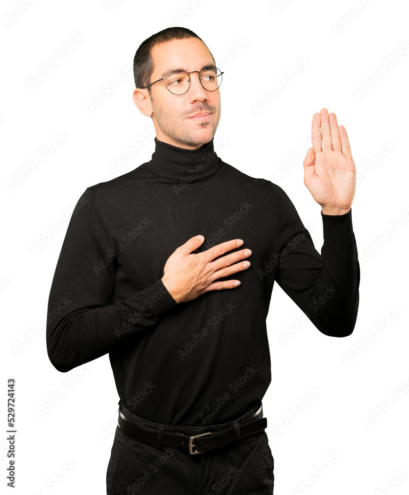 Fototapeta premium Serious young man with a gesture of oath