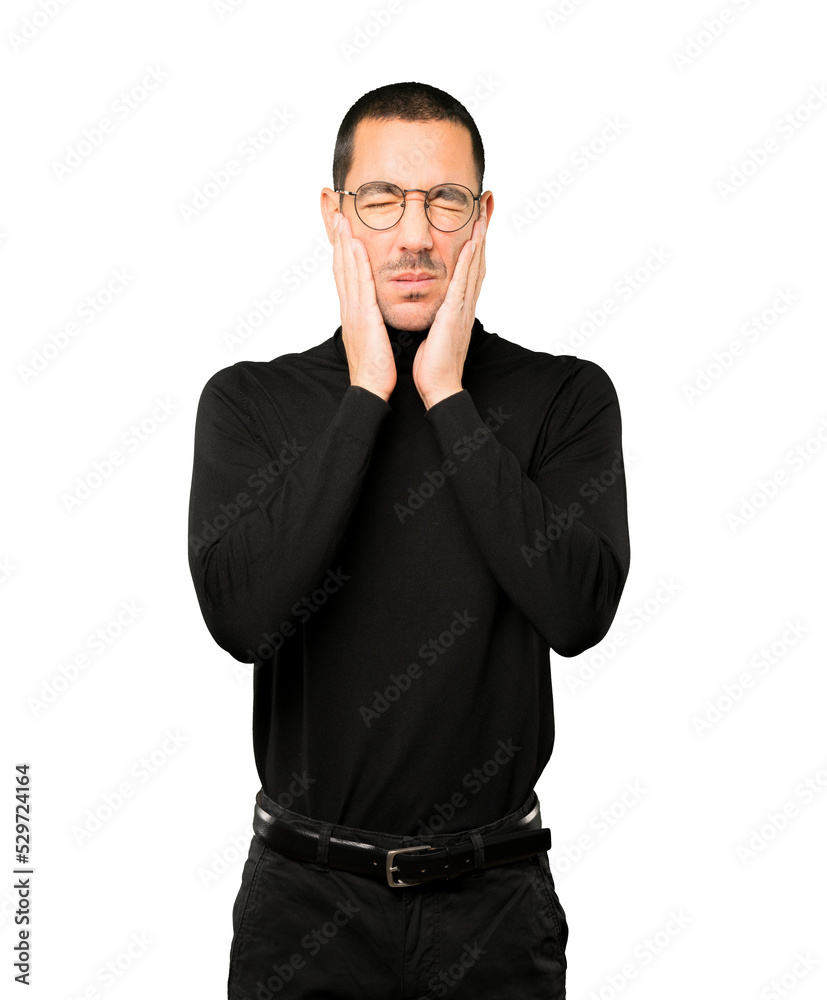 Concerned young man doing a gesture of relief Concerned young man doing a gesture of relief