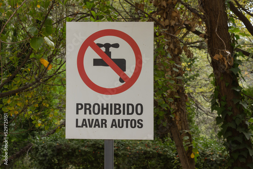 Sign in spanish indicating: forbidden to wash cars.