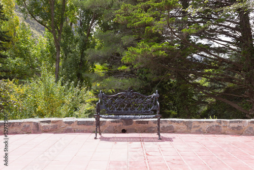 Iron  bench in a forest on a sunny day.