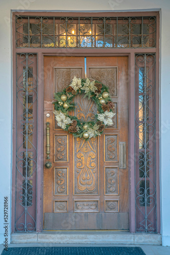 Downtown Tucson, Arizona- Carved door with wreath and railings on the transom window and sidelights