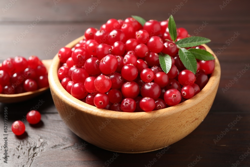 Fresh ripe cranberry on wooden table, closeup Fresh ripe cranberry on wooden table, closeup