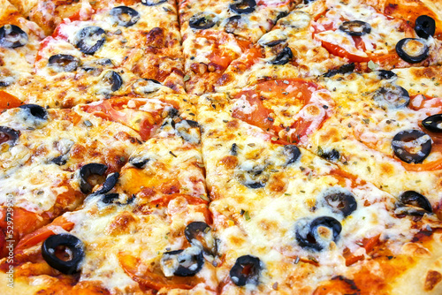 Pizza margarita close-up, for the whole frame. Pizza with tomatoes, cheese, olives.