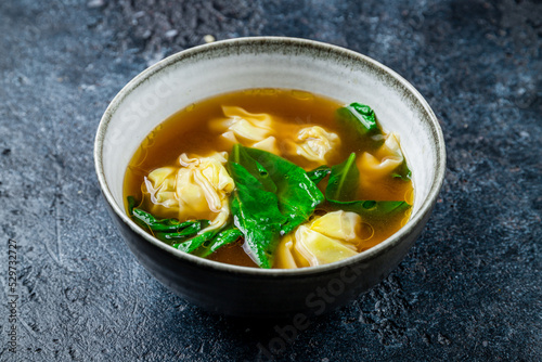 wonton soup on dark stone table, chinese cuisine