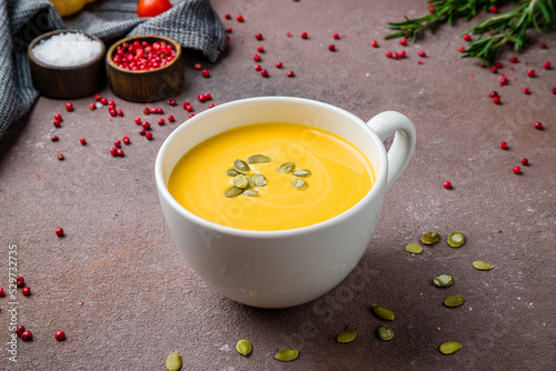 Soup cream of pumpkin on brown table