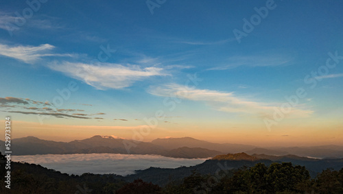 sunrise over the mountains in forest.