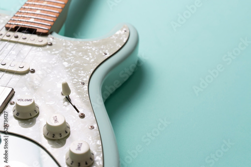 Electric guitar on green table background, close up music concept photo