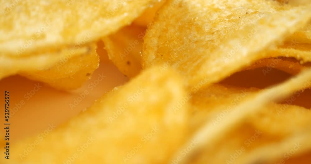 golden chips macro closeup, salty crunch snack. High quality 4k footage golden chips macro closeup, salty crunch snack. High quality 4k footage