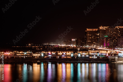 city skyline at night sea reflections