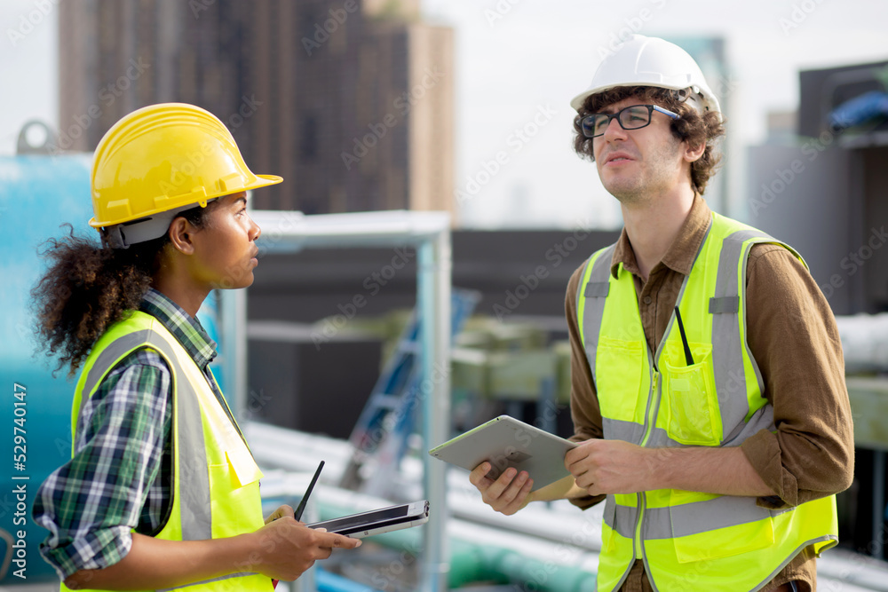 Young man and woman is architect planning and inspector project and looking digital tablet at construction site, engineer male and female working and examining for development real estate. Young man and woman is architect planning and inspector project and looking digital tablet at construction site, engineer male and female working and examining for development real estate.