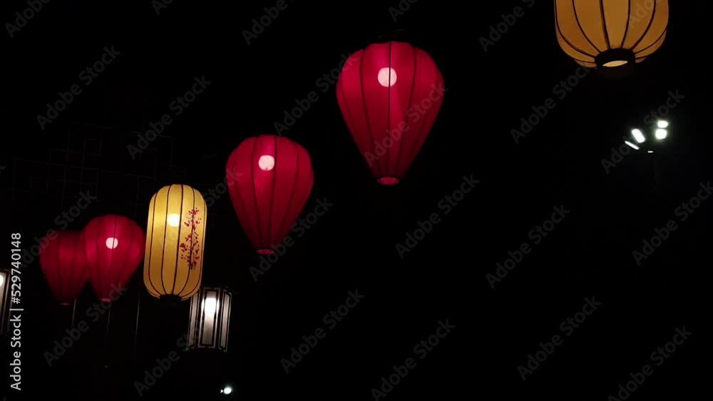 Several hanging paper lanterns, beautifully lit at night. The lantern swayed in the wind. Several hanging paper lanterns, beautifully lit at night. The lantern swayed in the wind.