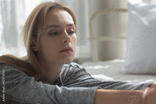 Young caucasian woman is depression and having mental problem in the bedroom at home, emotion and negative, woman loneliness and worry with disappoint, expression and hopelessness, lifestyles concept.
