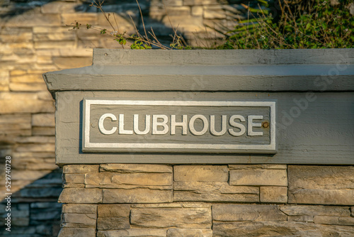 La Jolla, California- Clubhouse label on a wall outside with stones photo