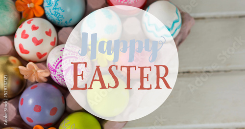 Image of happy easter text over easter eggs