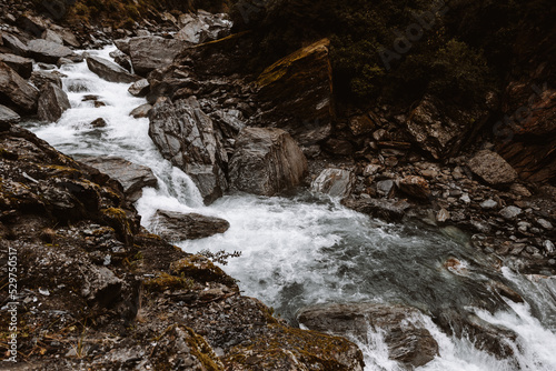 A stoney river runs through a valley in New Zealand