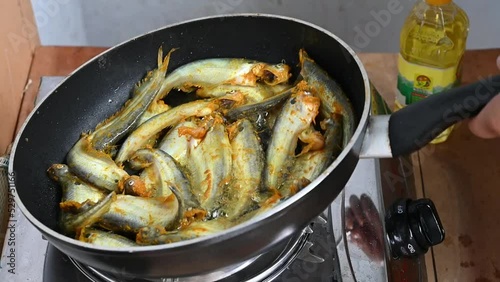 Frying pabda fish in hot oil. Slow motion video photo