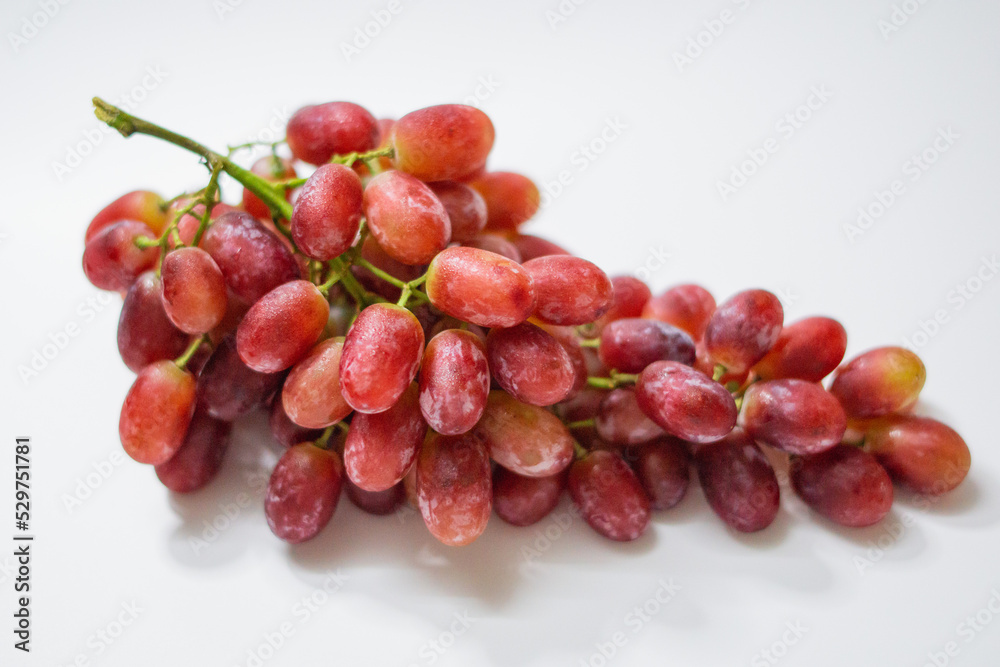 1 bunch of red ripe grapes on a white background