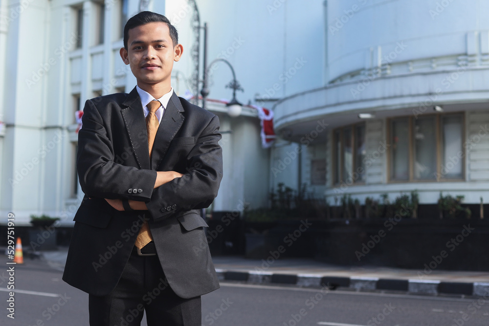 Successful businessman portrait with arms crossed smiling happy at the city. Successful businessman portrait with arms crossed smiling happy at the city.