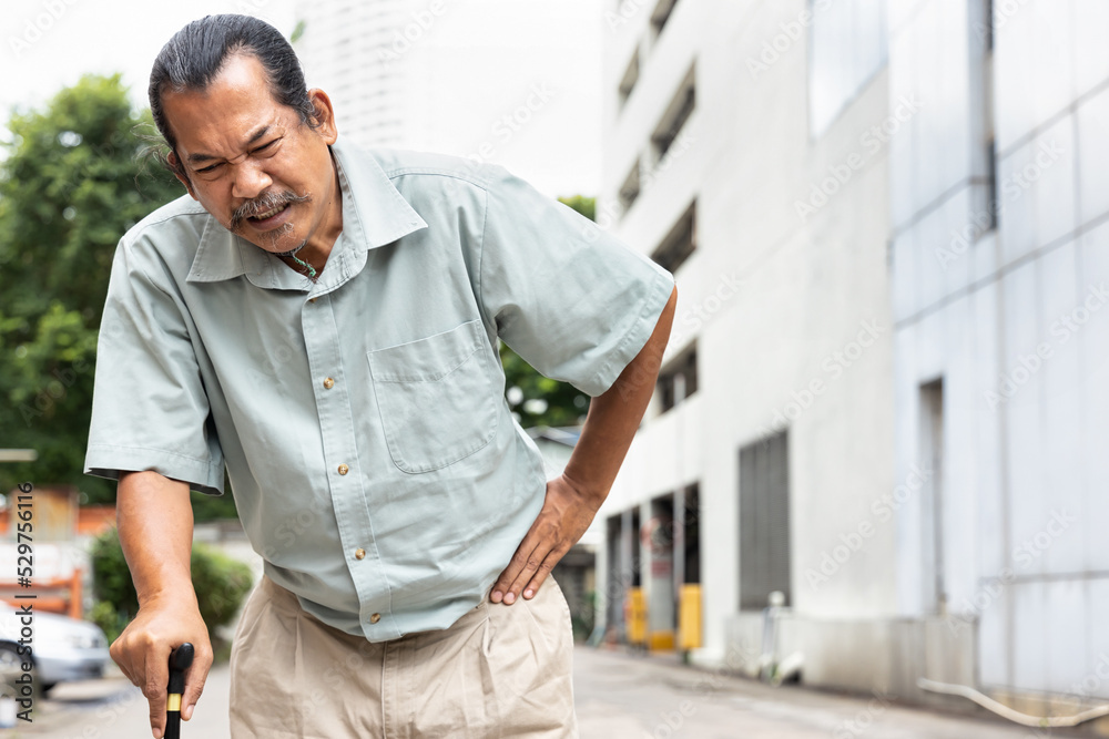 old senior man with either leg, knee, waist, hip pain using walking