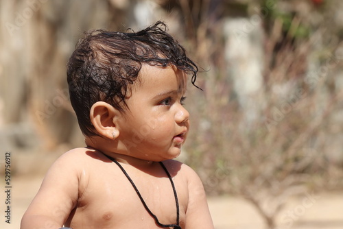 photo side view of beautiful happy baby boy with smiling faces, Rajasthan India