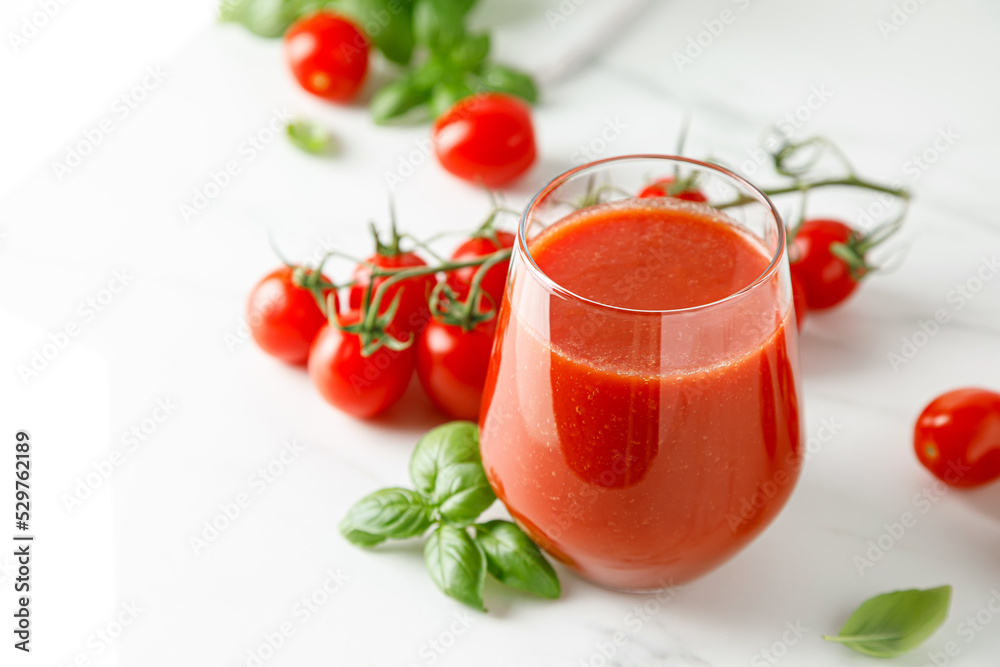 Tomato juice in a glass and fresh tomatoes Tomato juice in a glass and fresh tomatoes