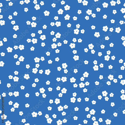 Simple vintage pattern. small white flowers . blue background. Fashionable print for textiles and wallpaper.
