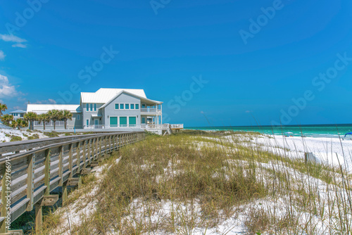 Boardwalk and beach house near the white sand shore of a beach at Destin, Florida