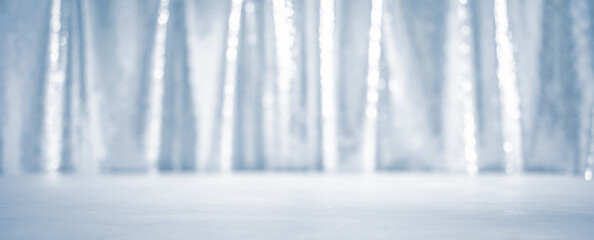 Shiny light blue curtain over white ice floor for Christmas or winter holidays background