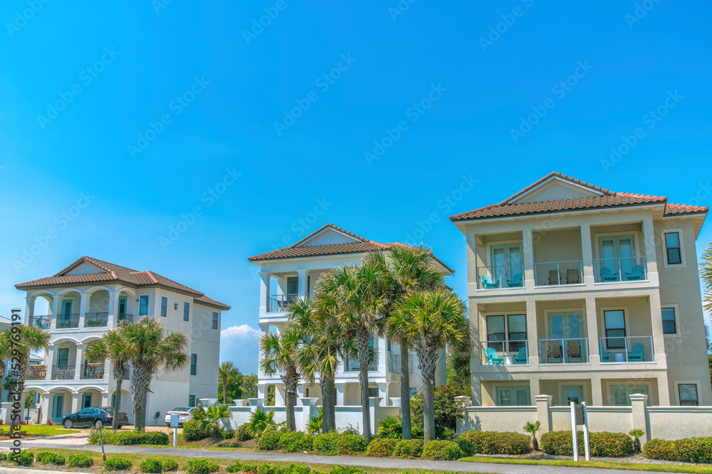 Destin, Florida- Facade of fenced three-storey beach houses