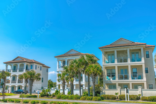 Fototapeta Naklejka Na Ścianę i Meble -  Destin, Florida- Facade of fenced three-storey beach houses
