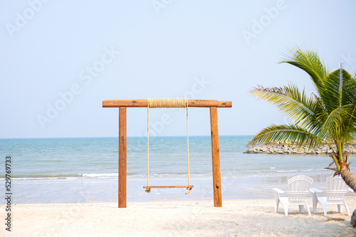 One swing is placed by the sea during the day, giving a relaxing holiday feeling. © topkritsada