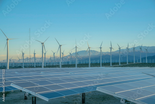 фотографія Solar panels and wind turbines against the sunset sky on a desert in California