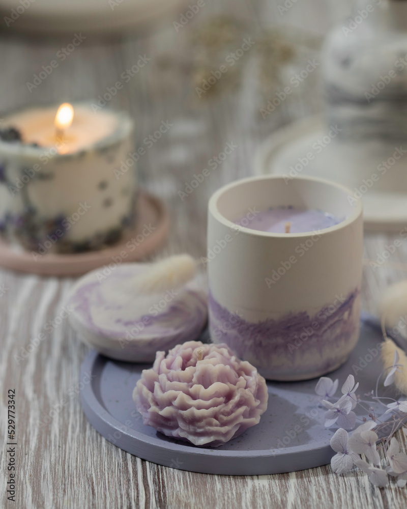 Soy candle in a concrete, plaster candlestick, decor interior. Home decoration with a burning scented candle. Spa. Natural. Soy candle in a concrete, plaster candlestick, decor interior. Home decoration with a burning scented candle. Spa. Natural.