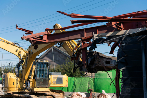 Demolition machine cutting steel frame, construction industry