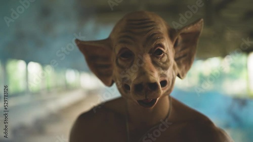 angry maniac with mask industrial background with smoke granade
