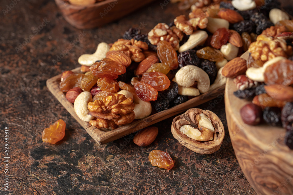 Mix of nuts and raisins on a brown rustic background. Mix of nuts and raisins on a brown rustic background.