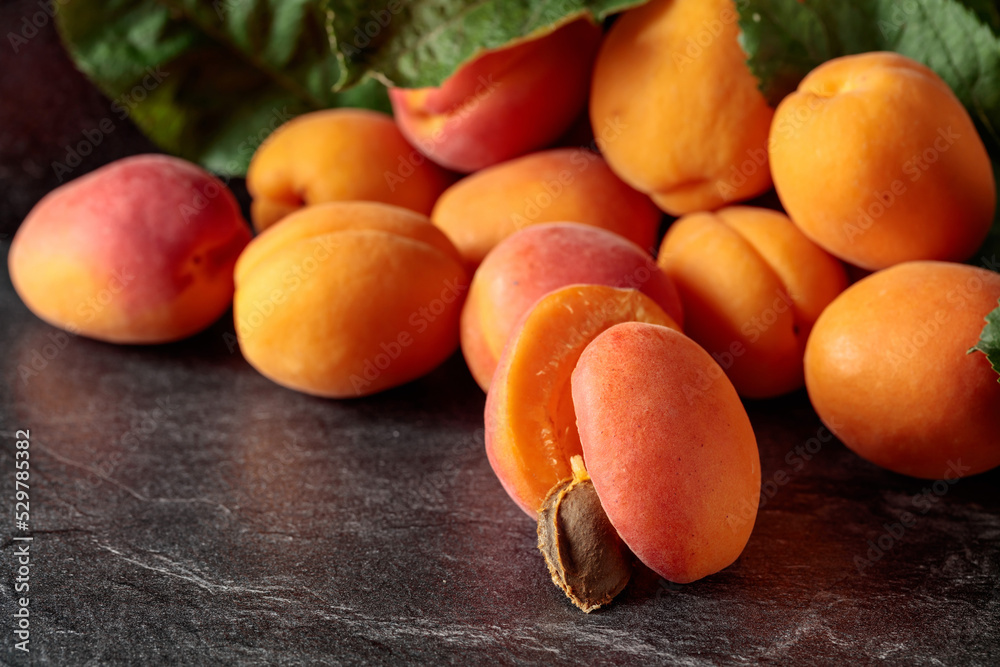 Apricots on a black stone table.