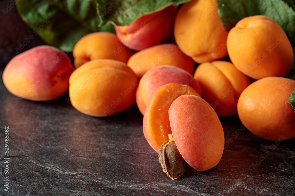 Apricots on a black stone table. Apricots on a black stone table.