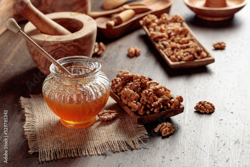 Honey and walnut on a old wooden table.