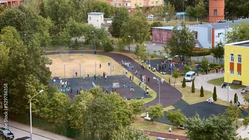 Wallpaper Mural The motion activity of schoolchildren on the sports ground of the school stadium. High-angle view. Time Lapse Torontodigital.ca